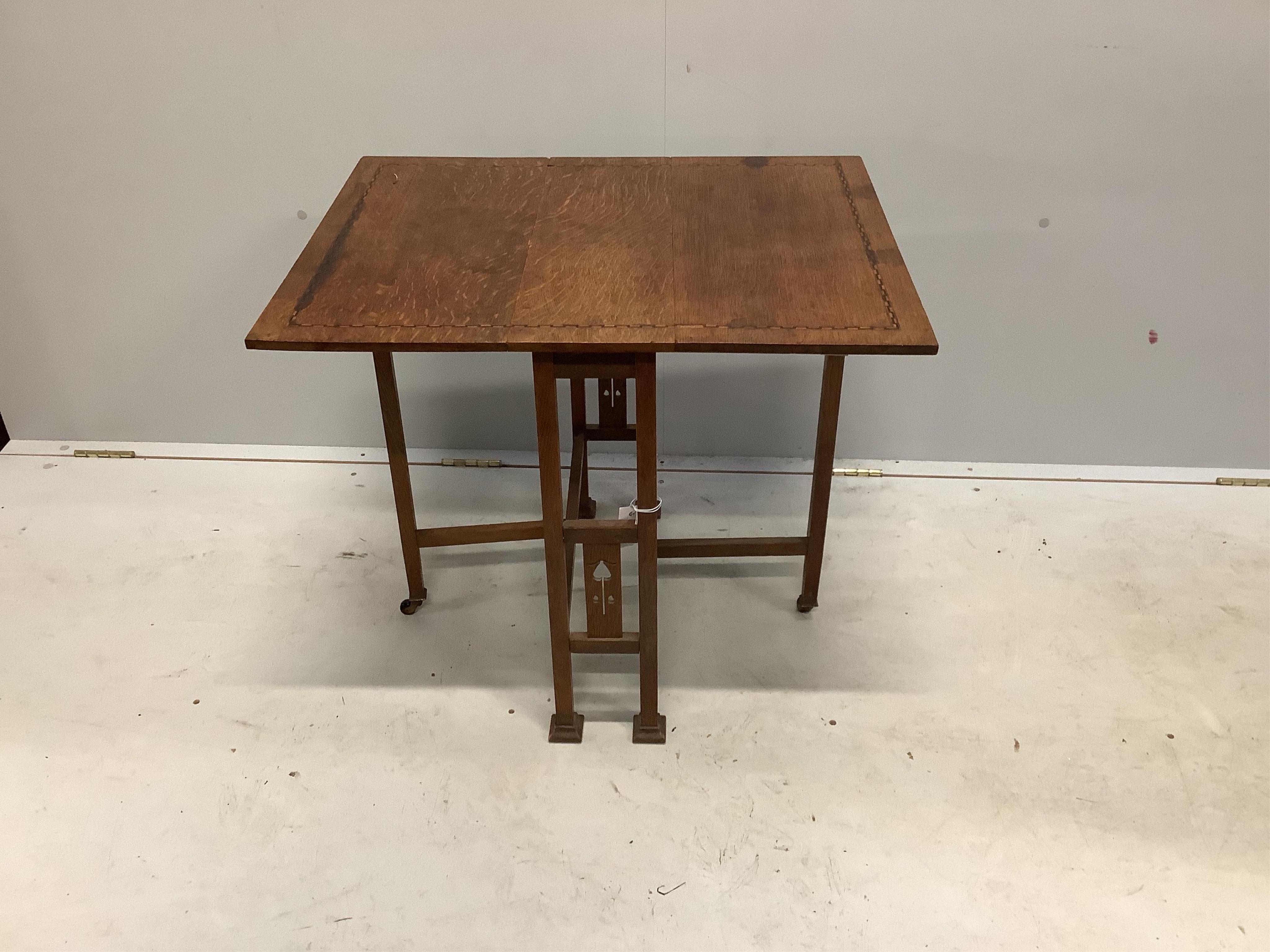 An Arts & Crafts inlaid oak Sutherland table, probably by Liberty of London, width 56cm, depth 20cm, height 60cm. Condition - fair